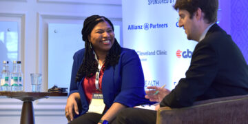 Rosie Hewat, Group Chief People Officer, HR and People Operations at Kuda with Editor Owain Thomas presents: Employer Demands for a Contemporary International Benefits Offering, at the Health Protection iPMI Summit at Pennyhill Park, Surrey, hosted by Definite Article Media. Photo by Michael Walter/Troika